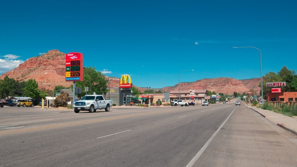Small town street with desert mountains and roadside shops Utah