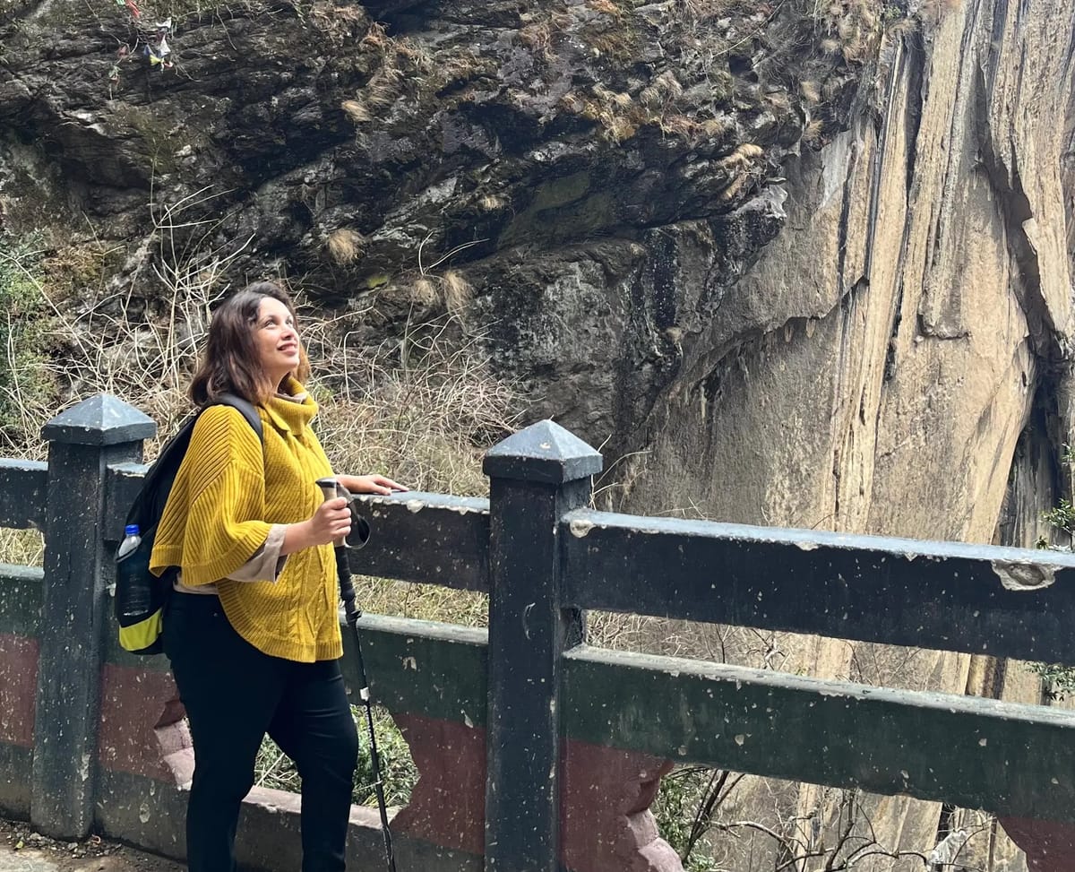Disha trekking to Tiger’s Nest Monastery during her solo Bhutan trip with Thrillophilia.